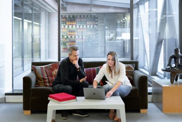 man-woman-in-office-on-laptop